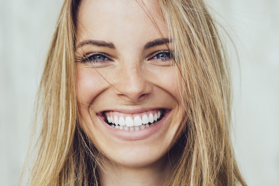 woman smiling big with a bright smile after professional teeth whitening