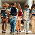 kids wearing backpacks for back to school dental checkups are on the list