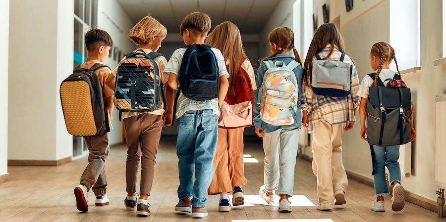 kids wearing backpacks for back to school dental checkups are on the list