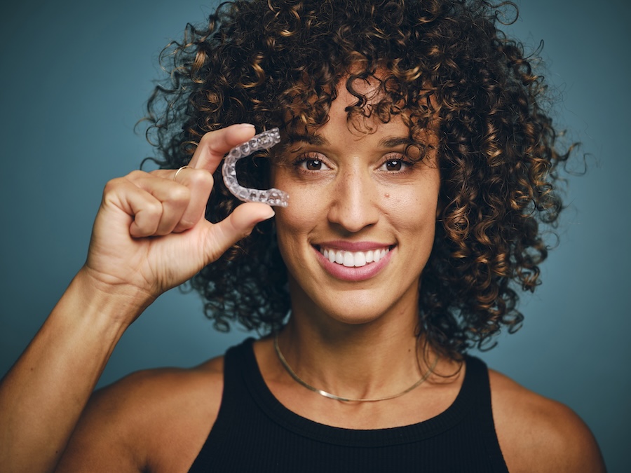 woman invisalign candidate holding clear aligner